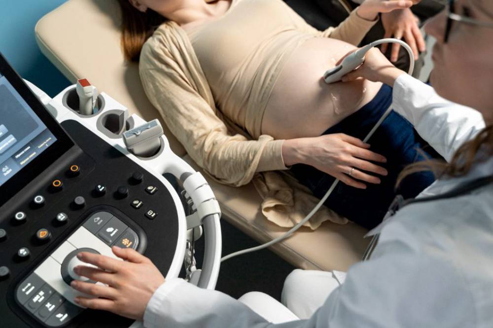 Healthcare professional performing an ultrasound on a pregnant woman